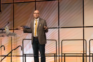 Matt Miller on stage speaking at an event